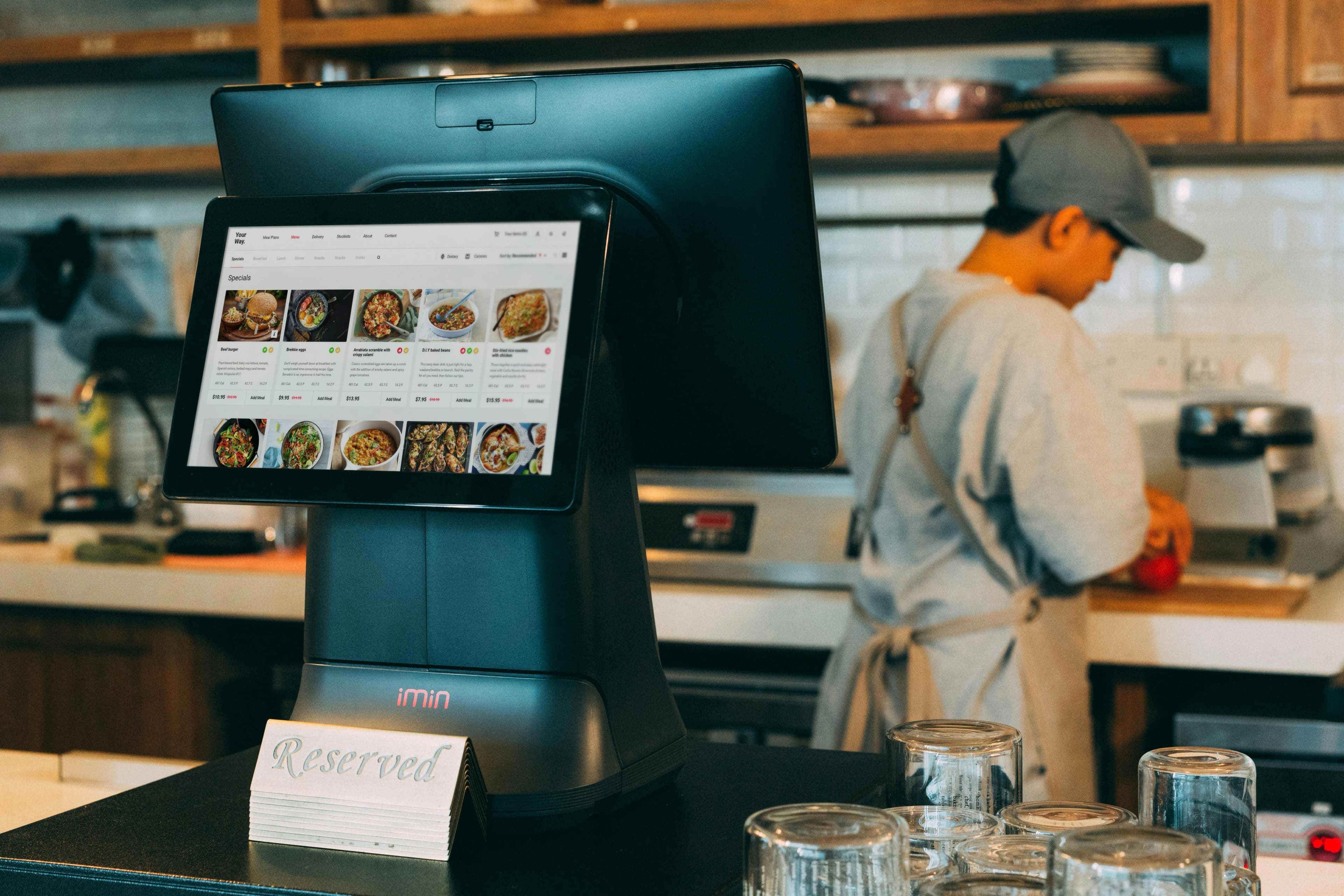 Reservation kiosk and table marker reinforcing measured booking outcomes